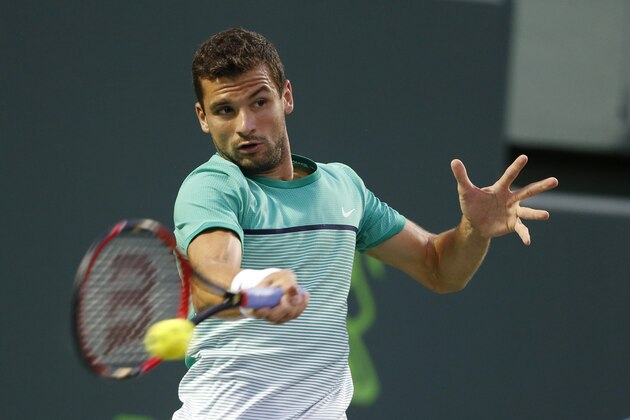 Grigor Dimitrov, of Bulgaria, returns a shot from Gael Monfils, of France, at the Miami Open tennis tournament, Tuesday, March 29, 2016, in Key Biscayne, Fla. (AP Photo/Wilfredo Lee)