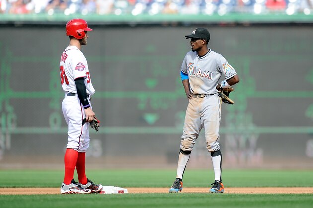 WASHINGTON, DC - SEPTEMBER 20: Bryce Harper #34 of the Washington Nationals talks with Dee Gordon #9 of the Miami Marlins during the game at Nationals Park on September 20, 2015 in Washington, DC.  (Photo by G Fiume/Getty Images)