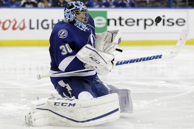 Tampa Bay Lightning goalie Ben Bishop takes a shot off his face mask by the Detroit Red Wings during the third period of Game 5 in a first-round NHL hockey Stanley Cup playoff series Thursday, April 21, 2016, in Tampa, Fla. (AP Photo/Chris O'Meara)