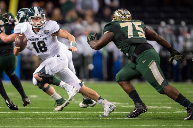 Jan 1, 2015; Arlington, TX, USA; Michigan State Spartans quarterback Connor Cook (18) tries to elude Baylor Bears defensive tackle Andrew Billings (75) during the first half in the 2015 Cotton Bowl Classic at AT&T Stadium. Mandatory Credit: Jerome Miron-USA TODAY Sports