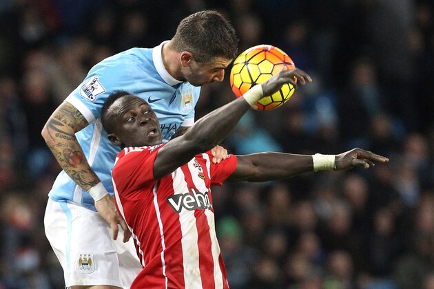 Manchester City's Serbian defender Aleksandar Kolarov (L) vies with Southampton's Senegalese midfielder Sadio Mane during the English Premier League football match between Manchester City and Southampton at The Etihad stadium in Manchester, north west England on November 28, 2015. AFP PHOTO / LINDSEY PARNABY

RESTRICTED TO EDITORIAL USE. No use with unauthorized audio, video, data, fixture lists, club/league logos or 'live' services. Online in-match use limited to 75 images, no video emulation. No use in betting, games or single club/league/player publications. / AFP / LINDSEY PARNABY        (Photo credit should read LINDSEY PARNABY/AFP/Getty Images)