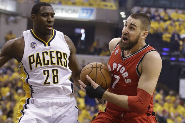 Toronto Raptors' Jonas Valanciunas (17) goes to the basket against Indiana Pacers' Ian Mahinmi (28) during the first half of Game 6 of an NBA first-round playoff basketball series Friday, April 29, 2016, in Indianapolis. (AP Photo/Darron Cummings)