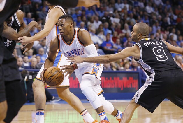 Oklahoma City Thunder guard Russell Westbrook (0) drives past San Antonio Spurs guard Tony Parker (9) during an NBA basketball game between the San Antonio Spurs and the Oklahoma City Thunder in Oklahoma City, Wednesday, Oct. 28, 2015. (AP Photo/Sue Ogrocki)