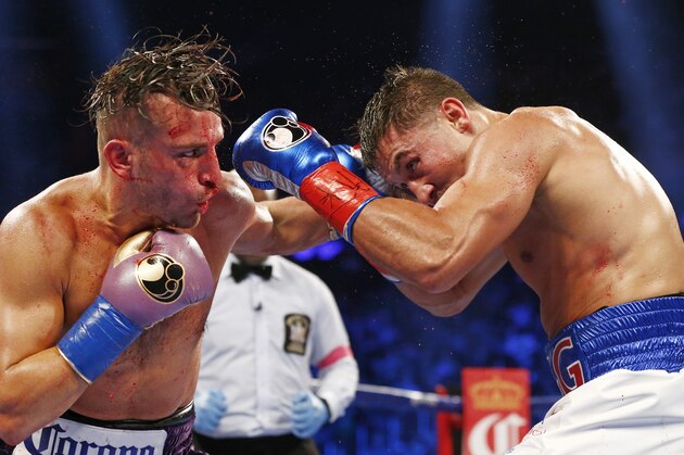 David Lemieux, left, hits Gennady Golovkin with a left punch in the seventh round of a middleweight title fight at Madison Square Garden in New York on Saturday, Oct. 17, 2015. Golovkin won in the eighth round. (AP Photo/Rich Schultz)