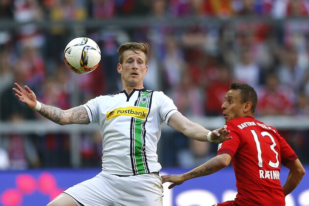 Moenchengladbach's Andre Hahn, left, and Bayern's Rafinha challenge for the ball during the German Bundesliga soccer match between FC Bayern Munich and Borussia Moenchengladbach at the Allianz Arena stadium in Munich, Germany, Saturday, April 30, 2016. (AP Photo/Matthias Schrader)