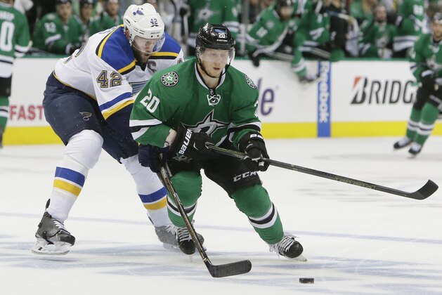 Dallas Stars center Cody Eakin (20) and St. Louis Blues center David Backes (42) chase the puck during the first period in Game 1 in the second round of the NHL Stanley Cup playoffs Friday, April 29, 2016, in Dallas. (AP Photo/LM Otero)