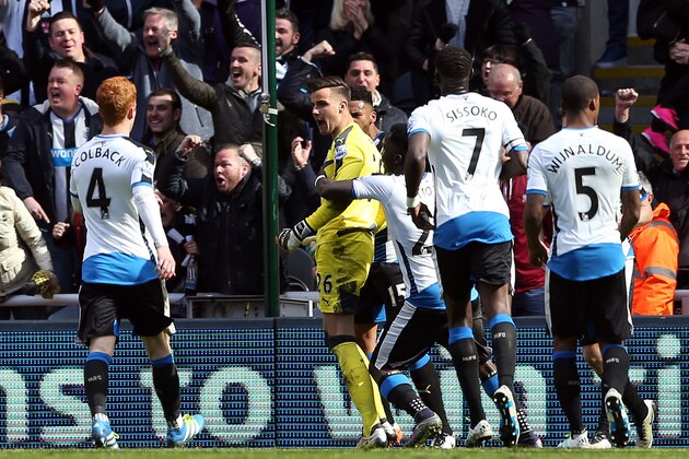 Newcastle United players congratulate Newcastle United's English goalkeeper Karl Darlow (C) after he saved a penalty kick from Crystal Palace's French midfielder Yohan Cabaye during the English Premier League football match between Newcastle United and Crystal Palace at St James' Park in Newcastle-upon-Tyne, north east England on April 30, 2016. / AFP / SCOTT HEPPELL        (Photo credit should read SCOTT HEPPELL/AFP/Getty Images)