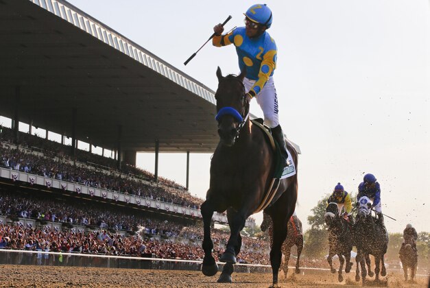 FILE - In this June 6, 2015, file photo, Victor Espinoza reacts after crossing the finish line with American Pharoah to win the Belmont Stakes horse race at Belmont Park in Elmont, N.Y. American Pharoah’s sweep of the Kentucky Derby, Preakness and Belmont Stakes for horse racing’s first Triple Crown since 1978 was selected the sports story of the year Thursday, Dec. 24, 2015, in an annual vote conducted by The Associated Press. (AP Photo/Julio Cortez, File)