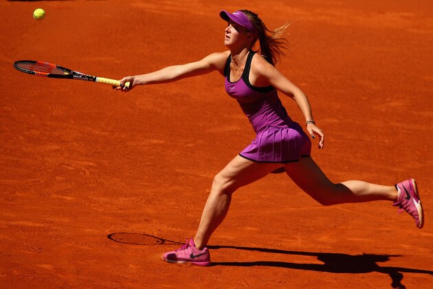 MADRID, SPAIN - APRIL 30:  Elina Svitolina of the Ukraine stretches for a forehand against Yanina Wickmayer of Belgium in their first round  match during day one of the Mutua Madrid Open tennis tournament at the Caja Magica on April 30, 2016 in Madrid, Spain.  (Photo by Clive Brunskill/Getty Images)