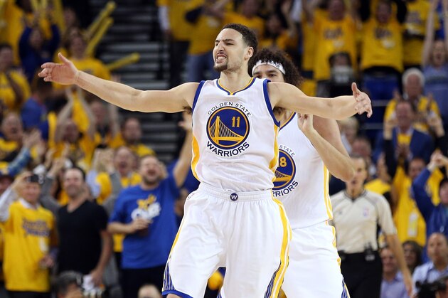 OAKLAND, CA - APRIL 27:  Klay Thompson #11 of the Golden State Warriors and Anderson Varejao #18 of the Golden State Warriors celebrate after Thompson made a three-point basket against the Houston Rockets in Game Five of the Western Conference Quarterfinals during the 2016 NBA Playoffs at ORACLE Arena on April 27, 2016 in Oakland, California. NOTE TO USER: User expressly acknowledges and agrees that, by downloading and or using this photograph, user is consenting to the terms and conditions of Getty Images License Agreement.  (Photo by Ezra Shaw/Getty Images)