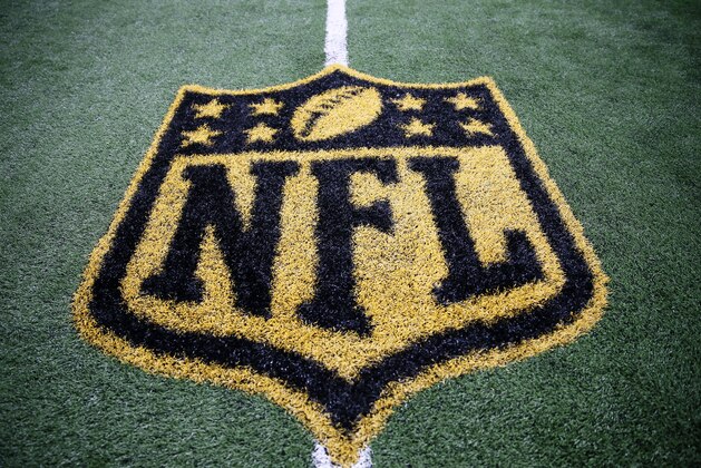The gold colored NFL logo on the field is shown after a preseason NFL football game between the Minnesota Vikings and Dallas Cowboys Saturday, Aug. 29, 2015, in Arlington, Texas. (AP Photo/Tony Gutierrez)