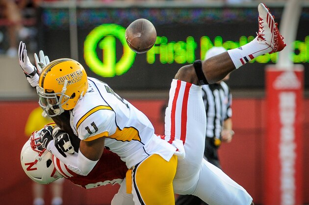 LINCOLN, NE - SEPTEMBER 7: Wide receiver Quincy Enunwa #18 of the Nebraska Cornhuskers fights for a ball with defensive back Kalan Reed #11 of the Southern Miss Golden Eagles during their game at Memorial Stadium on September 7, 2013 in Lincoln, Nebraska. (Photo by Eric Francis/Getty Images)