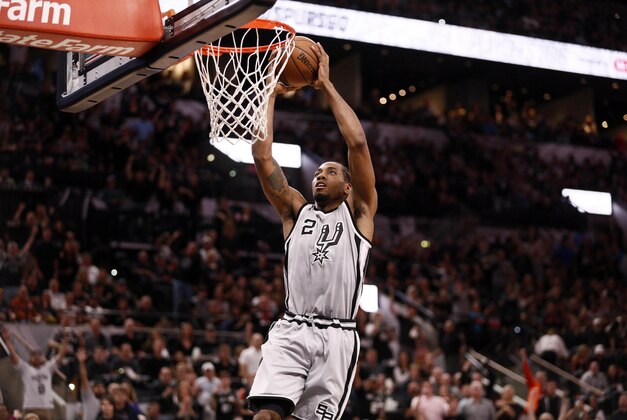 Apr 17, 2016; San Antonio, TX, USA; San Antonio Spurs small forward Kawhi Leonard (2) dunks the ball against the Memphis Grizzlies during the first half in game one of the first round of the NBA Playoffs at AT&T Center. Mandatory Credit: Soobum Im-USA TODAY Sports