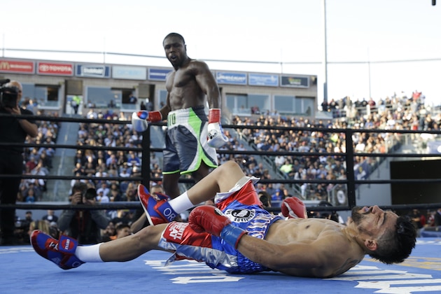 Victor Ortiz, front, is knocked down by Andre Berto during the fourth round of a welterweight boxing match, Saturday, April 30, 2016, in Carson, Calif. Berto won by knockout in the fourth round. (AP Photo/Jae C. Hong)
