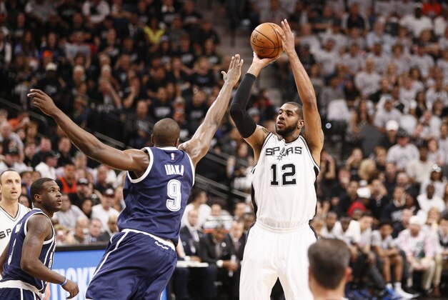 Apr 30, 2016; San Antonio, TX, USA; San Antonio Spurs power forward LaMarcus Aldridge (12) shoots the ball over Oklahoma City Thunder power forward Serge Ibaka (9) in game one of the second round of the NBA Playoffs at AT&T Center. Mandatory Credit: Soobum Im-USA TODAY Sports