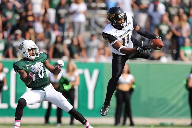 Oct 24, 2015; Charlotte, NC, USA; Southern Miss Golden Eagles defensive back Kalan Reed (11) leaps in the air for an interception intended for Charlotte 49ers wide receiver Austin Duke (10 during the second quarter at Jerry Richardson Stadium. Mandatory Credit: Jim Dedmon-USA TODAY Sports