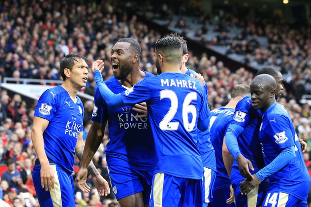 Leicester's Wes Morgan, second left, celebrates with teammates after scoring during the English Premier League soccer match between Manchester United and Leicester at Old Trafford Stadium, Manchester, England, Sunday, May 1, 2016. (AP Photo/Jon Super)