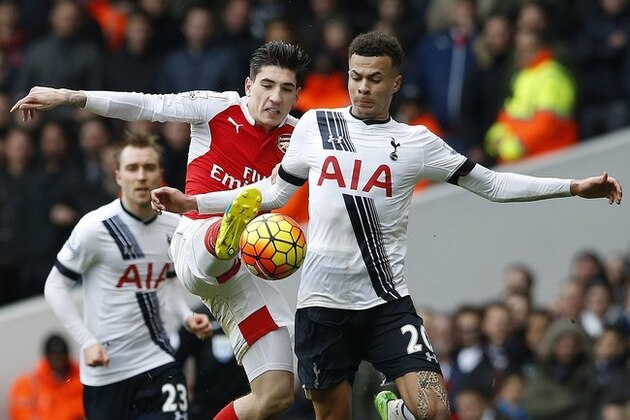 Tottenham Hotspur’s Dele Alli, right, is challenged by Arsenal's Hector Bellerin during the English Premier League soccer match between Tottenham Hotspur and Arsenal at the White Hart Lane stadium in London, Saturday, March, 5, 2016. (AP Photo/Alastair Grant)