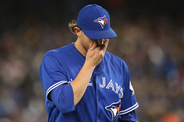 TORONTO, CANADA - APRIL 24: Brett Cecil #27 of the Toronto Blue Jays walks to the dugout at the end of the seventh inning during MLB game action against the Oakland Athletics on April 24, 2016 at Rogers Centre in Toronto, Ontario, Canada. (Photo by Tom Szczerbowski/Getty Images)