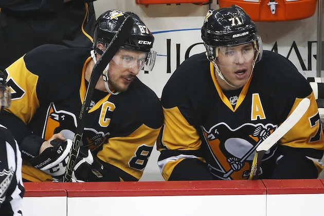 Pittsburgh Penguins' Sidney Crosby (87) and Evgeni Malkin (71) sit on the bench during the first period of a first-round NHL playoff hockey game against the New York Rangers in Pittsburgh, Saturday, April 16, 2016. (AP Photo/Gene J. Puskar)