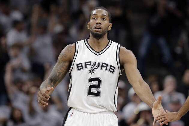 San Antonio Spurs forward Kawhi Leonard (2) reaches out to a teammate after he score against the Oklahoma City Thunder during the first half in Game 1 of a second-round NBA basketball playoff series, Saturday, April 30, 2016, in San Antonio. (AP Photo/Eric Gay)