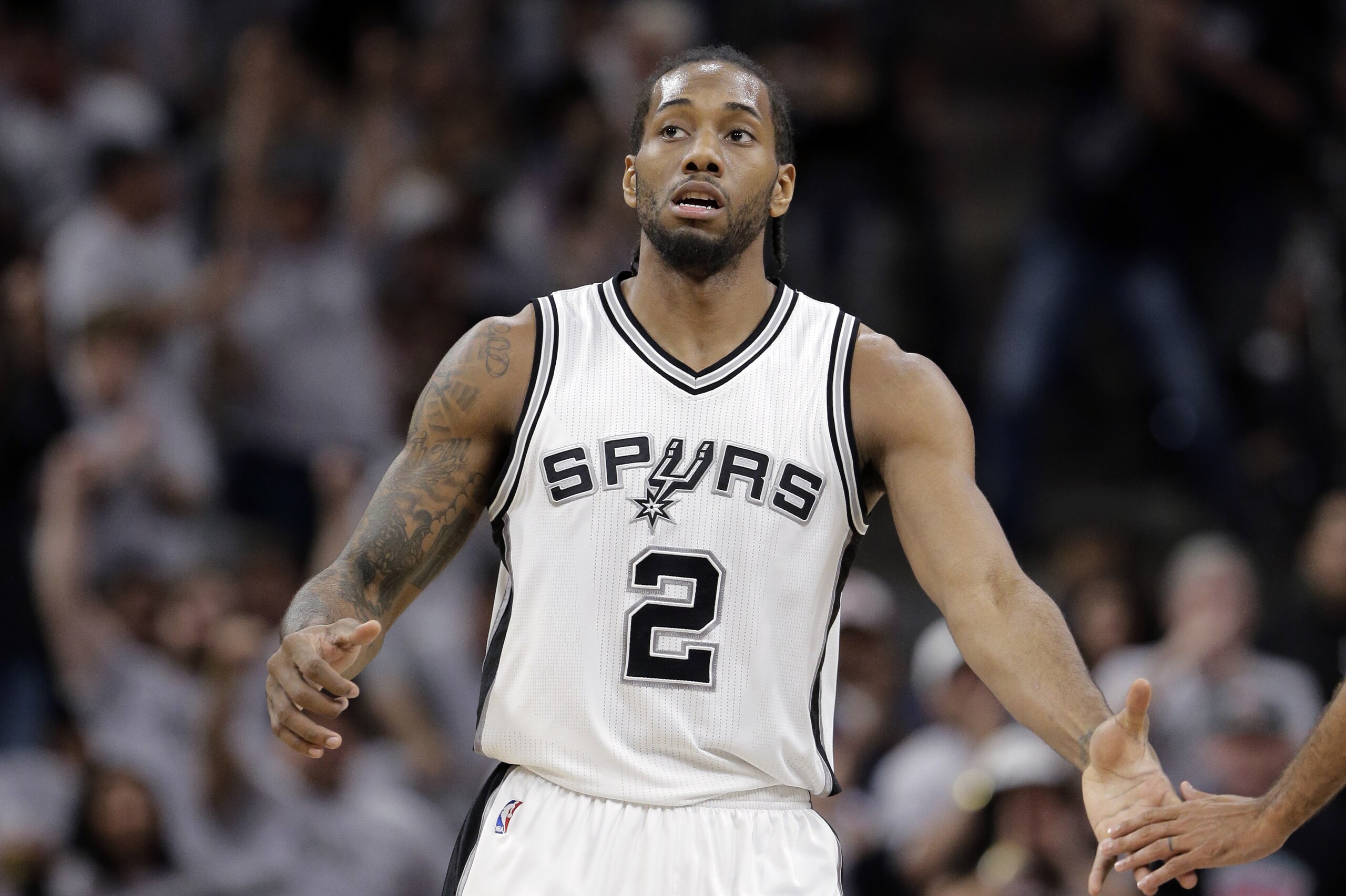 San Antonio Spurs forward Kawhi Leonard (2) reaches out to a teammate after he score against the Oklahoma City Thunder during the first half in Game 1 of a second-round NBA basketball playoff series, Saturday, April 30, 2016, in San Antonio. (AP Photo/Eric Gay) San Antonio Spurs forward Kawhi Leonard (2) reaches out to a teammate after he score against the Oklahoma City Thunder during the first half in Game 1 of a second-round NBA basketball playoff series, Saturday, April 30, 2016, in San Antonio. (AP Photo/Eric Gay)