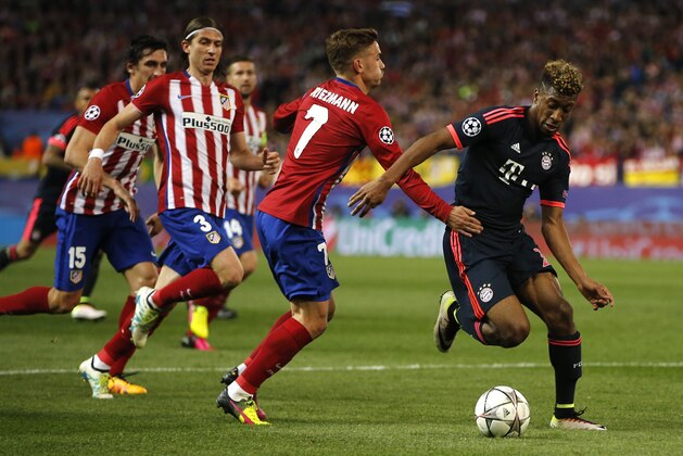 Atletico's Antoine Griezmann, left, and Bayern’s Kingsley Coman challenge for the ball during the Champions League 1st leg semifinal soccer match between Atletico Madrid and Bayern Munich at the Vicente Calderon stadium in Madrid, Spain, Wednesday, April 27, 2016. (AP Photo/Paul White)