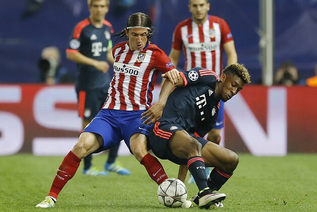 Atletico's Filipe Luis, left, and Bayern’s Kingsley Coman challenge for the ball during the Champions League 1st leg semifinal soccer match between Atletico Madrid and Bayern Munich at the Vicente Calderon stadium in Madrid, Spain, Wednesday, April 27, 2016. (AP Photo/Francisco Seco)