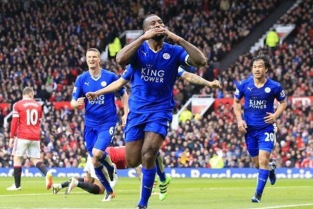 Leicester's Wes Morgan, centre, celebrates after scoring during the English Premier League soccer match between Manchester United and Leicester at Old Trafford Stadium, Manchester, England, Sunday, May 1, 2016. (AP Photo/Jon Super)