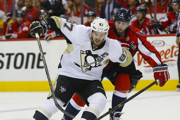 Pittsburgh Penguins center Sidney Crosby (87) and Washington Capitals defenseman Matt Niskanen (2) chase down the puck during the first period of Game 2 in an NHL hockey Stanley Cup Eastern Conference semifinals Saturday, April 30, 2016 in Washington. (AP Photo/Pablo Martinez Monsivais)