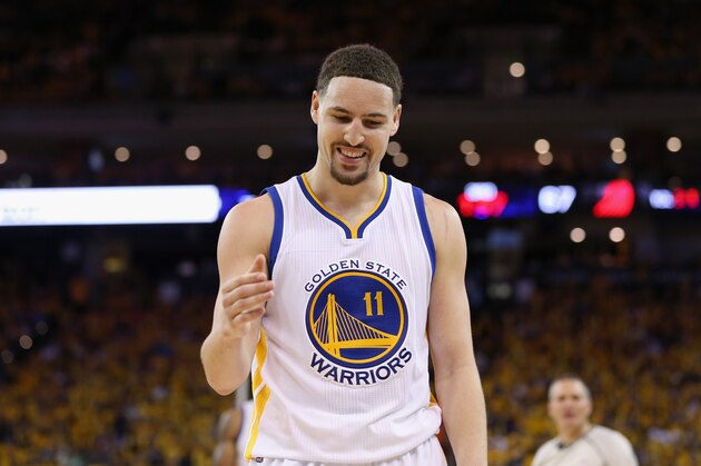 OAKLAND, CA - MAY 01:  Klay Thompson #11 of the Golden State Warriors smiles as he goes to help Leandro Barbosa #19 off the ground during their game against the Portland Trail Blazers during Game One of the Western Conference Semifinals for the 2016 NBA Playoffs at ORACLE Arena on May 01, 2016 in Oakland, California.  NOTE TO USER: User expressly acknowledges and agrees that, by downloading and or using this photograph, User is consenting to the terms and conditions of the Getty Images License Agreement.  (Photo by Ezra Shaw/Getty Images)