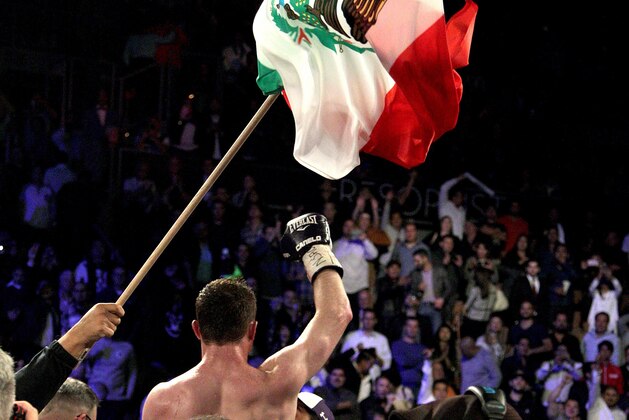 Saul 'Canelo' Alvarez of  Mexico  waves to fans following his unanimous decision victory over Miguel Cotto of Puerto Rico in their middleweight championship boxing match on November 21, 2015 at the Mandalay Bay Events Center in Las Vegas, Nevada.    AFP PHOTO / JOHN GURZINSKI        (Photo credit should read JOHN GURZINSKI/AFP/Getty Images)