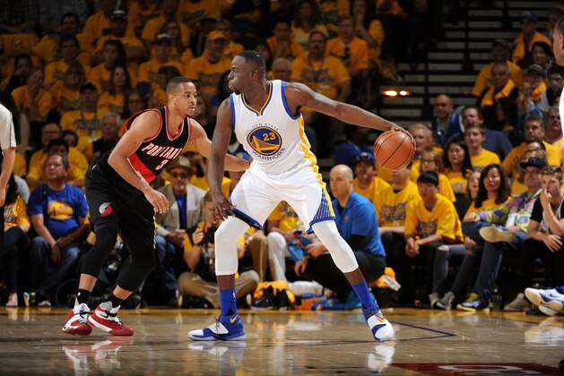 OAKLAND, CA - MAY 1: Draymond Green #23 of the Golden State Warriors handles the ball during the game against C.J. McCollum #3 of the Portland Trail Blazers in Game One of the Western Conference Semifinals during the 2016 NBA Playoffs on May 1, 2016 at ORACLE Arena in Oakland, California. NOTE TO USER: User expressly acknowledges and agrees that, by downloading and or using this photograph, user is consenting to the terms and conditions of Getty Images License Agreement. Mandatory Copyright Notice: Copyright 2016 NBAE (Photo by Garrett Ellwood/NBAE via Getty Images)