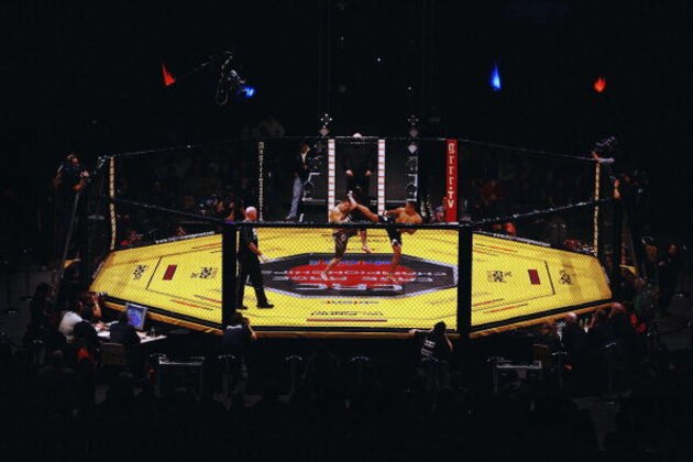 LONDON - FEBRUARY 10: Ashleigh Grimshaw in action against Ronnie Mann during the Cage Rage Championship 20 Born to fight event at Wembley Arena on February 10, 2007 in London, England. Cage Fighting also known as MMA Mixed Martial Arts is a mixed fighting style combat sport with a steadily growing international fan base. MMA is an evolving combat sport where competitors combine different disciplines that include jiu-jitsu, judo, karate, boxing, kickboxing, wrestling and others to their strategic and tactical advantage in a competetive arena.  (Photo by Daniel Berehulak/Getty Images)