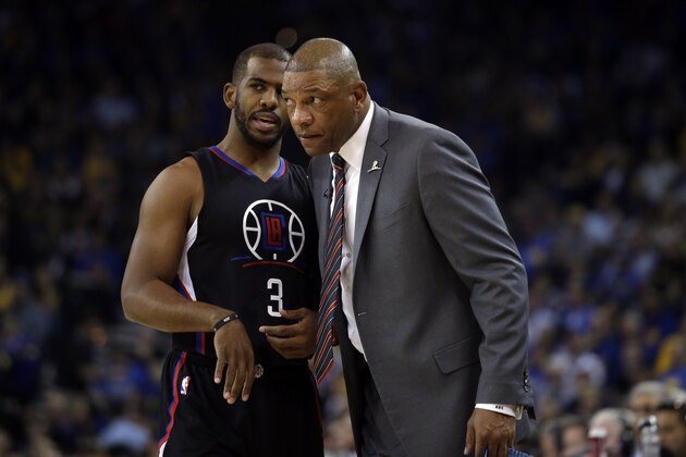Los Angeles Clippers coach Doc Rivers, right, talks to guard Chris Paul (3) during the first half of an NBA basketball game against the Golden State Warriors on Wednesday, March 23, 2016, in Oakland, Calif. (AP Photo/Marcio Jose Sanchez)