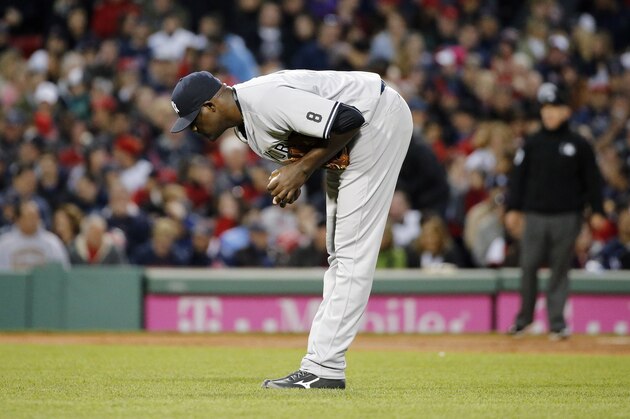 New York Yankees' Michael Pinedad pauses after a double by Boston Red Sox's Jackie Bradley Jr.during the second inning of a baseball game in Boston, Saturday, April 30, 2016. (AP Photo/Michael Dwyer)