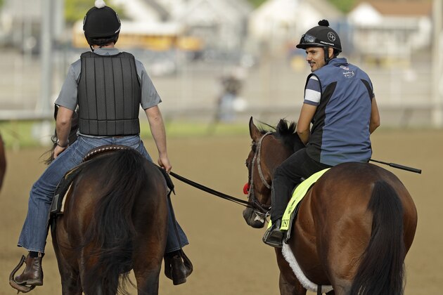 Kentucky Derby hopeful Nyquist, right, is ridden by exercise rider Johhy Garcia during a workout at Churchill Downs Monday, May 2, 2016, in Louisville, Ky. The 142nd running of the Kentucky Derby is scheduled for Saturday, May 7. (AP Photo/Charlie Riedel)