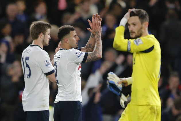 Tottenham's goalkeeper Hugo Lloris, right, wipes his head as Tottenham'sKyle Walker and Eric Dier applaud the fans after the English Premier League soccer match between Chelsea and Tottenham Hotspur at Stamford Bridge stadium in London, Monday, May 2, 2016. (AP Photo/Frank Augstein)