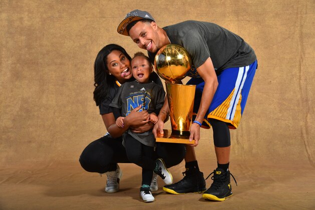 CLEVELAND, OH - JUNE 16: Ayesha Curry, Riley Curry and Stephen Curry #30 of the Golden State Warriors poses for a portrait with the Larry O'Brien trophy after defeating the Cleveland Cavaliers in Game Six of the 2015 NBA Finals on June 16, 2015 at Quicken Loans Arena in Cleveland, Ohio. NOTE TO USER: User expressly acknowledges and agrees that, by downloading and or using this photograph, user is consenting to the terms and conditions of Getty Images License Agreement. Mandatory Copyright Notice: Copyright 2015 NBAE (Photo by Jesse D. Garrabrant/NBAE via Getty Images)