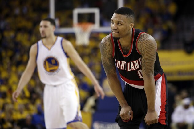 Portland Trail Blazers' Damian Lillard (0) pauses during a timeout next to Golden State Warriors' Klay Thompson, left, during the second half in Game 1 of a second-round NBA basketball playoff series, Sunday, May 1, 2016, in Oakland, Calif. Golden State won 118-106. (AP Photo/Marcio Jose Sanchez)