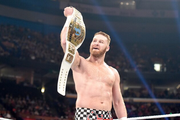 Sami Zayn holds up the Intercontinental Championship