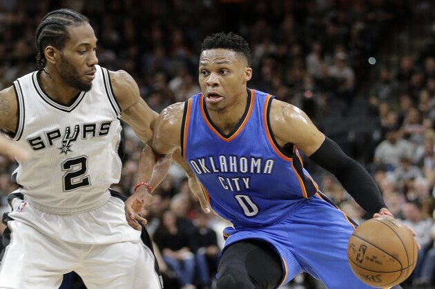 San Antonio Spurs' Kawhi Leonard (2) defends against a drive to the basket by Oklahoma City Thunder's Russell Westbrook (0) during the first half in Game 2 of a second-round NBA basketball playoff series, Monday, May 2, 2016, in San Antonio. (AP Photo/Eric Gay)