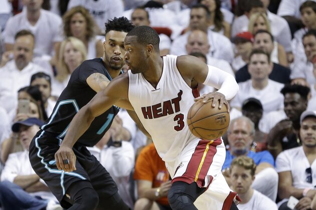 Miami Heat guard Dwyane Wade (3) drives around Charlotte Hornets guard Courtney Lee (1) during Game 7 of a first-round NBA basketball playoff series, Sunday, May 1, 2016, in Miami.  (AP Photo/Alan Diaz)