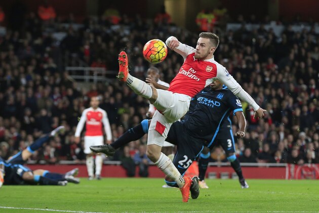 Arsenal's Aaron Ramsey, front, attempts to control the ball under pressure from Manchester City's Fernandinho, behind, during the English Premier League soccer match between Arsenal and Manchester City at the Emirates stadium in London, Monday, Dec. 21, 2015. (AP Photo/Alastair Grant)