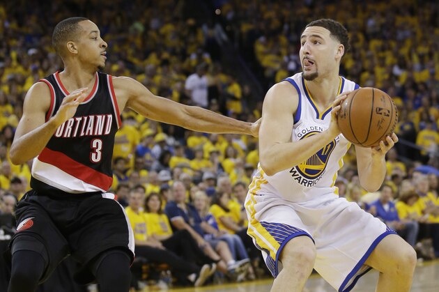 Golden State Warriors' Klay Thompson (11) is defended by Portland Trail Blazers' C.J. McCollum (3) during the second half in Game 1 of a second-round NBA basketball playoff series, Sunday, May 1, 2016, in Oakland, Calif. Golden State won 118-106. (AP Photo/Marcio Jose Sanchez)