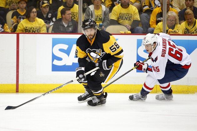 PITTSBURGH, PA - MAY 02:  Kris Letang #58 of the Pittsburgh Penguins handles the puck in front of Andre Burakovsky #65 of the Washington Capitals in Game Three of the Eastern Conference Second Round during the 2016 NHL Stanley Cup Playoffs at Consol Energy Center on May 2, 2016 in Pittsburgh, Pennsylvania.  (Photo by Justin K. Aller/Getty Images)