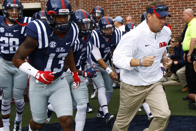 Mississippi football coach Hugh Freeze leads his players onto the field in an NCAA college football game against New Mexico State in Oxford, Miss., Saturday, Oct. 10, 2015. (AP Photo/Rogelio V. Solis)
