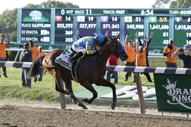 American Pharoah with Victor Espinoza up approaches the finish line during the 147th running of the Belmont Stakes horse race at Belmont Park, Saturday, June 6, 2015, in Elmont, N.Y. American Pharoah became the first horse since Affirmed in 37 years to win the Triple Crown. (AP Photo/Seth Wenig)