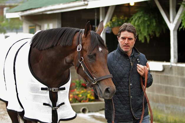 Trainer Keith Desormeaux walks Kentucky Derby hopeful Exaggerator following his gallop at Churchill Downs in Louisville, Ky., Tuesday, May 3, 2016. The 142nd Kentucky Derby is Saturday, May 7. (AP Photo/Garry Jones)