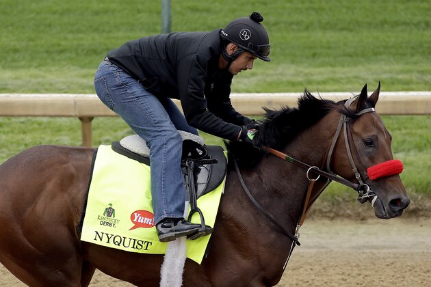 Exercise rider Jonny Garcia rides Kentucky Derby hopeful Nyquist during a workout at Churchill Downs Tuesday, May 3, 2016, in Louisville, Ky. The 142nd running of the Kentucky Derby is scheduled for Saturday, May 7. (AP Photo/Charlie Riedel)